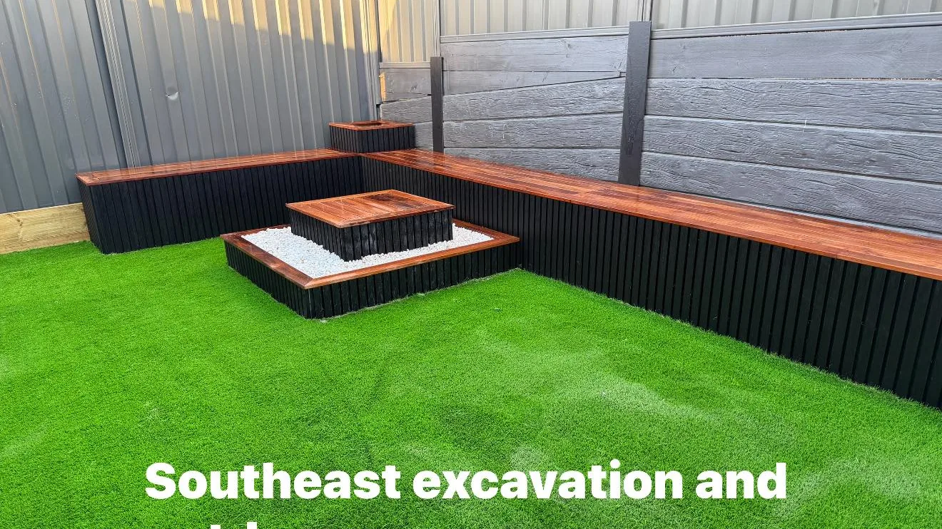 Backyard landscaping with bench and planter